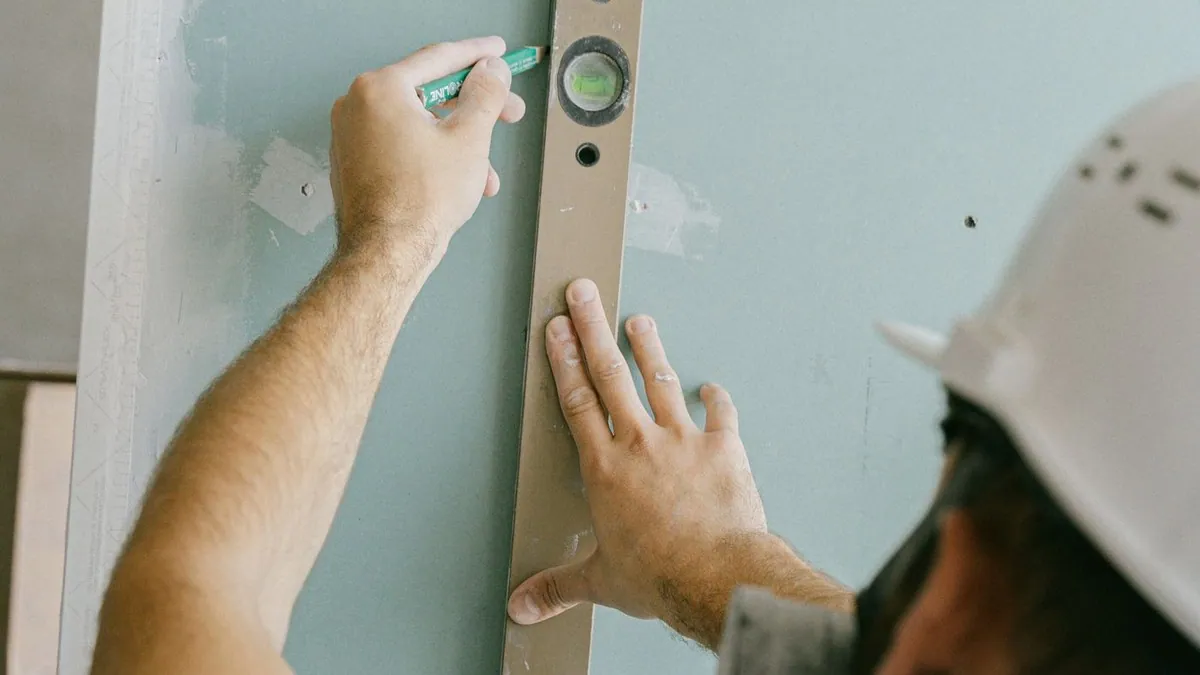 Worker using a spirit level to mark a wall during a renovation
