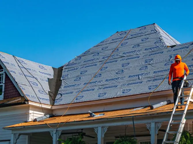 Roofer on a house with fresh underlayment